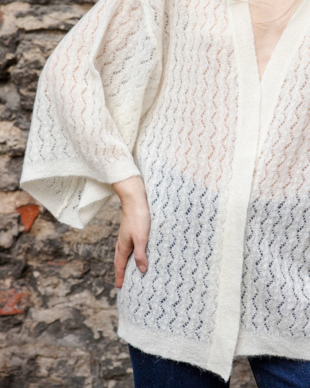 Close-up of the wide kimono sleeve and textured knit of the Adele & Soleil Jasmin natural white wrap cardigan.