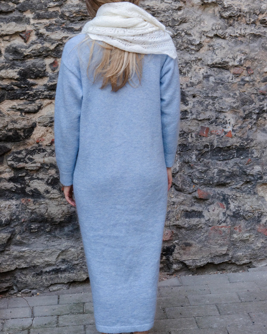 Full-length back view of a woman wearing the Adele & Soleil Lundi Matin sky blue longline cardigan.