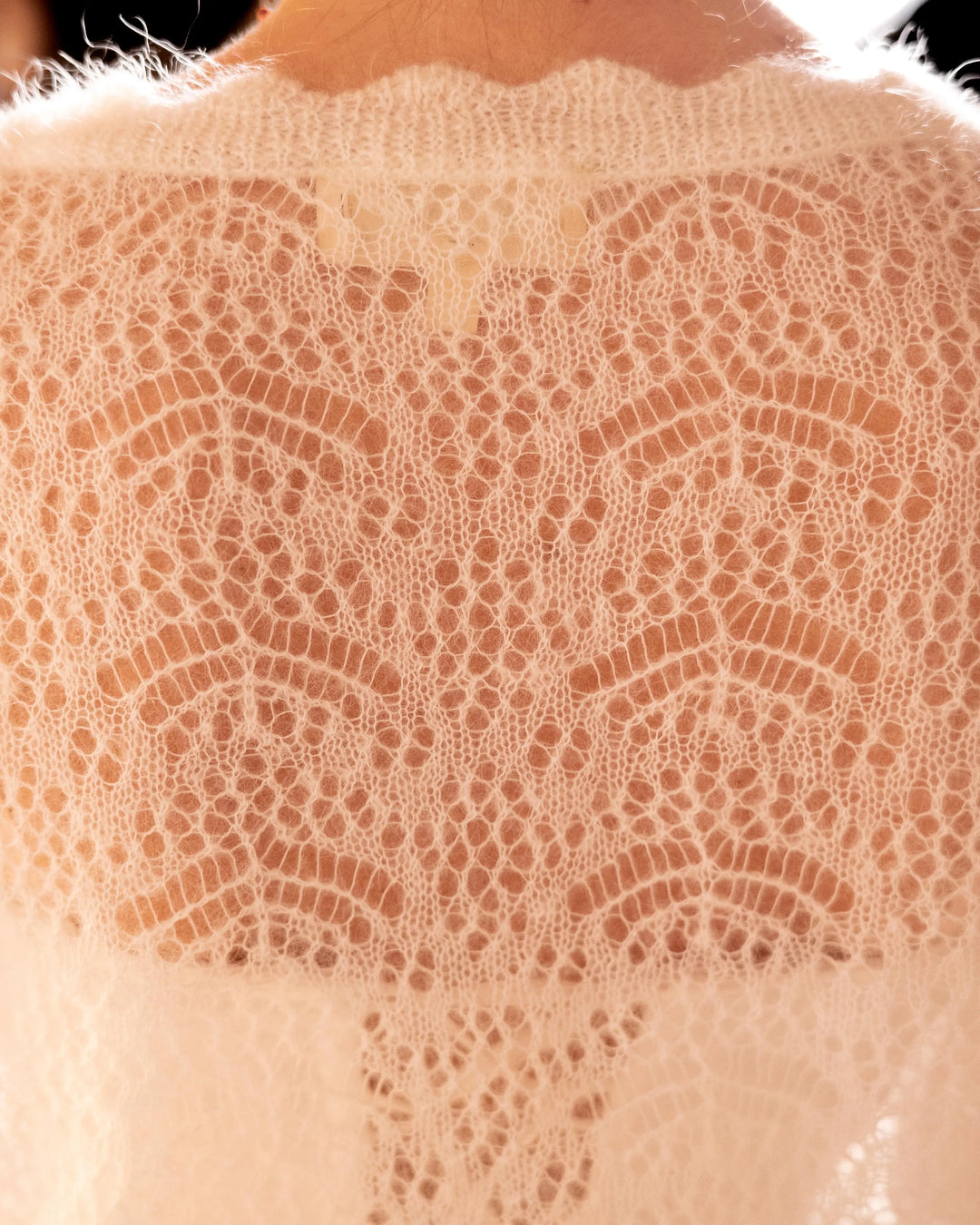Close-up of the back knit detail on the natural white Adele & Soleil Rêve V-neck cardigan.
